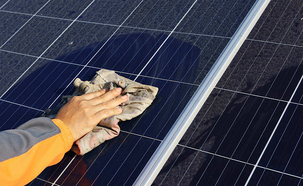 Hand cleaning solar panels, maintenance on solar energy system