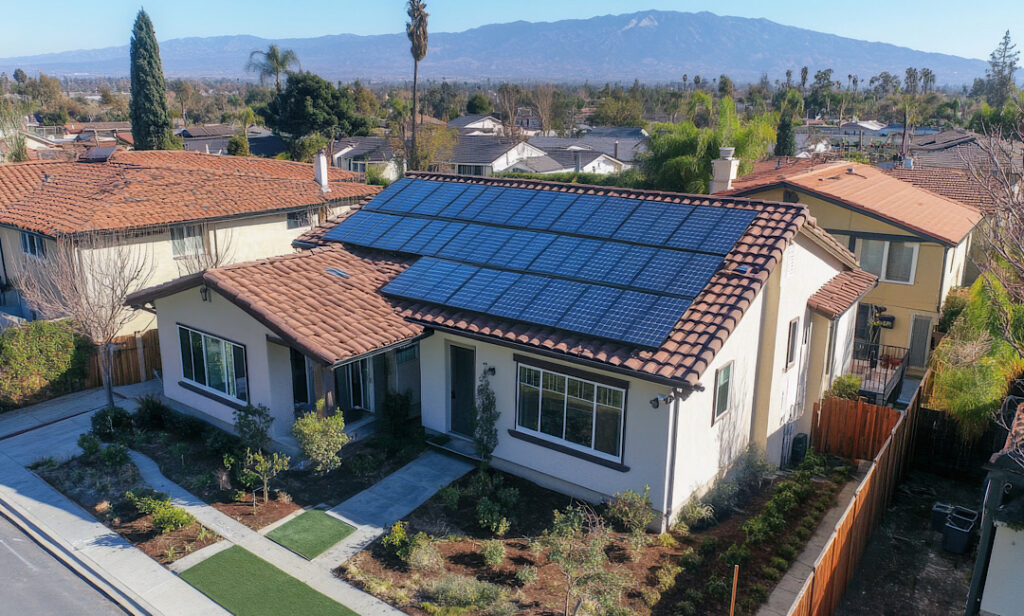 Residential rooftop solar panel installation on a home in an East Bay California neighborhood on a sunny day.
